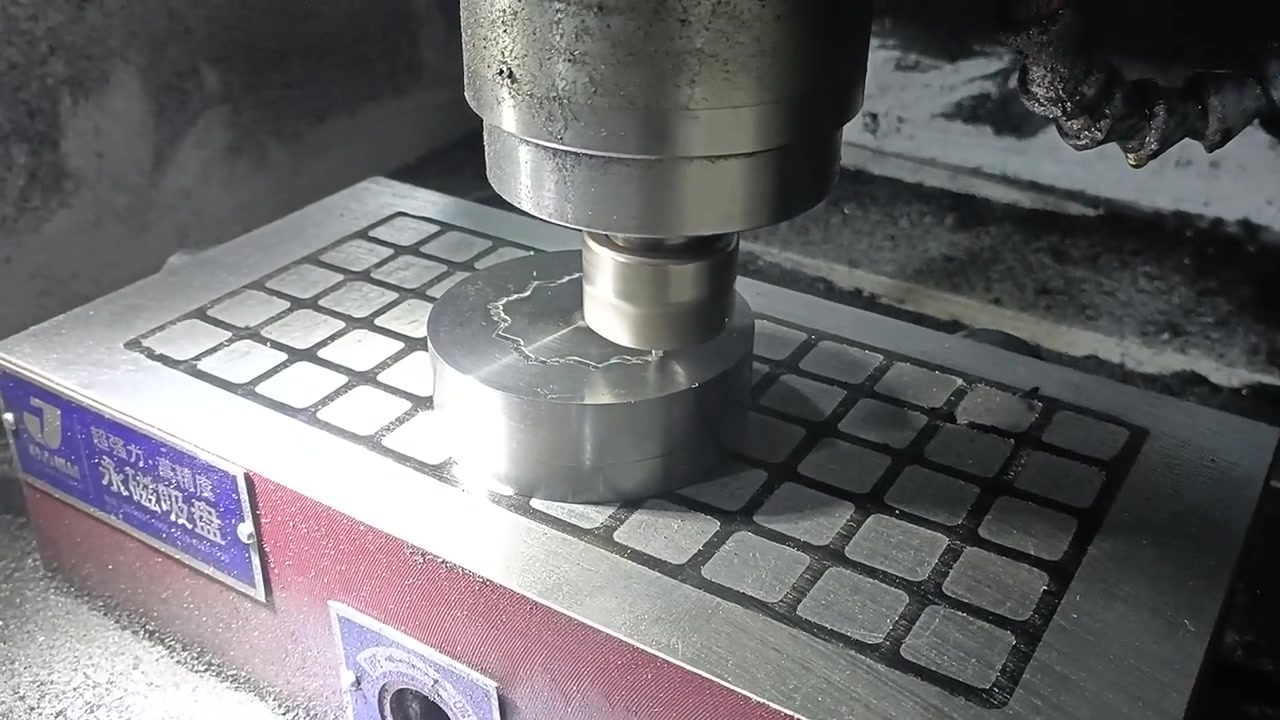 CNC machine engraving a custom coin mold with precision