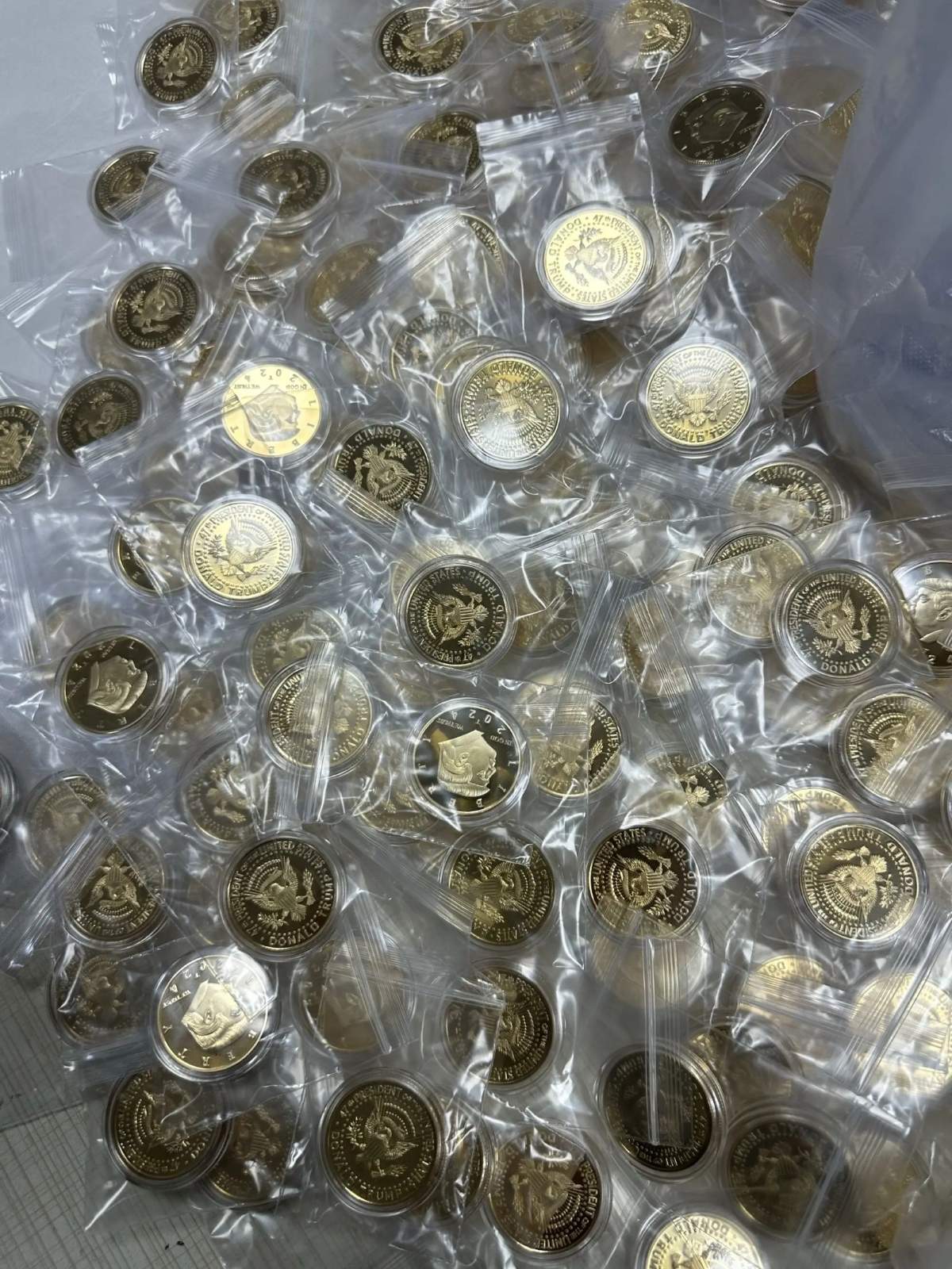 Gold and silver plated commemorative coins showing various finishes